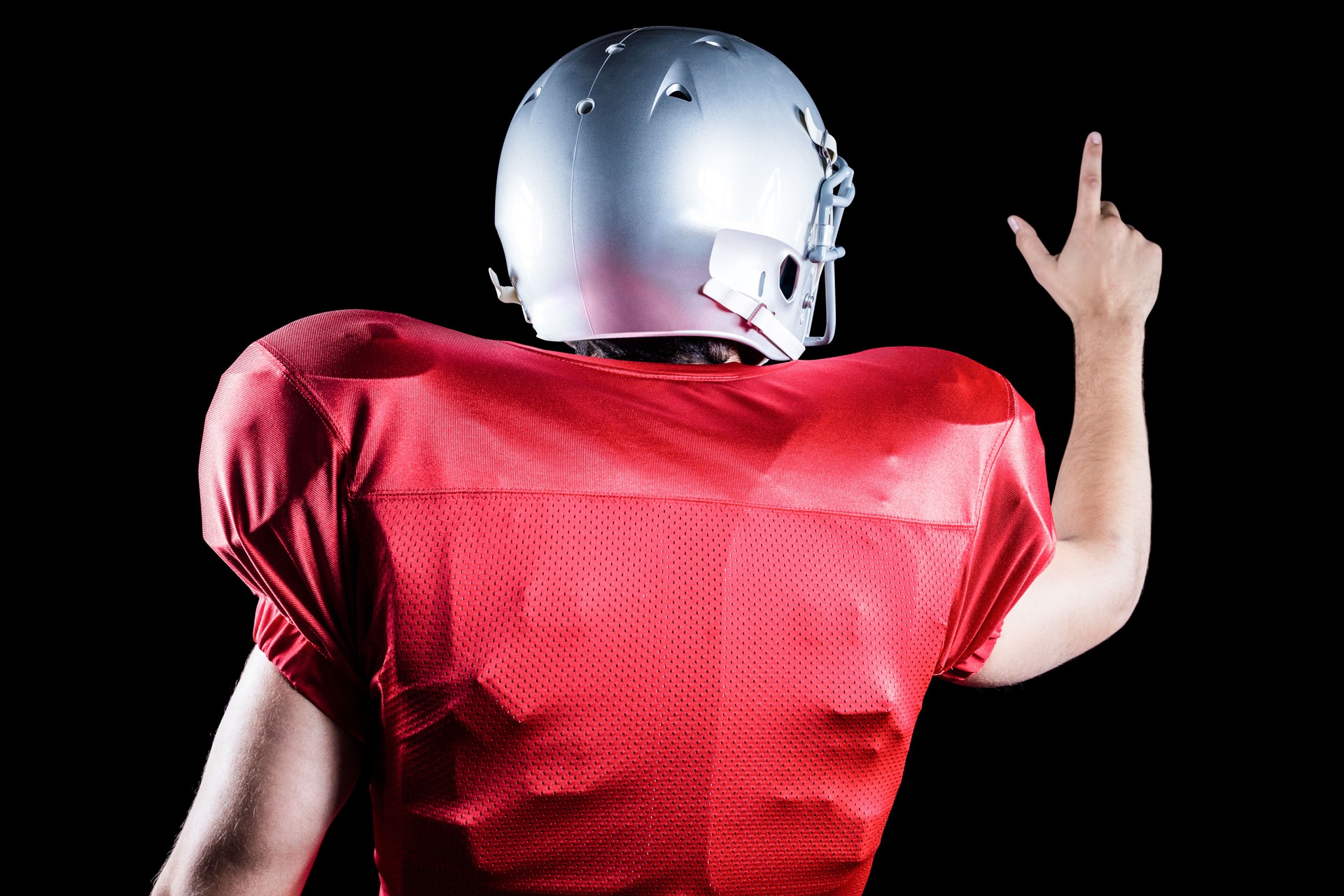 Rear view of American football player pointing